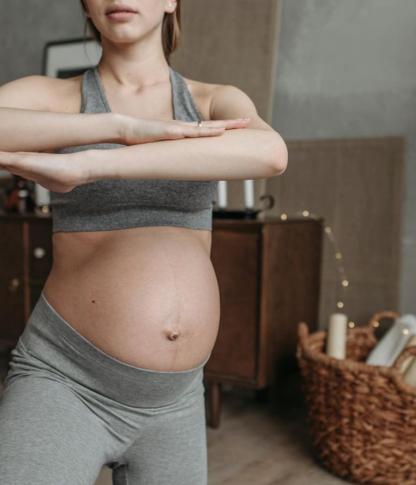 Woman practicing yoga outdoors in Mexico during a sunset.